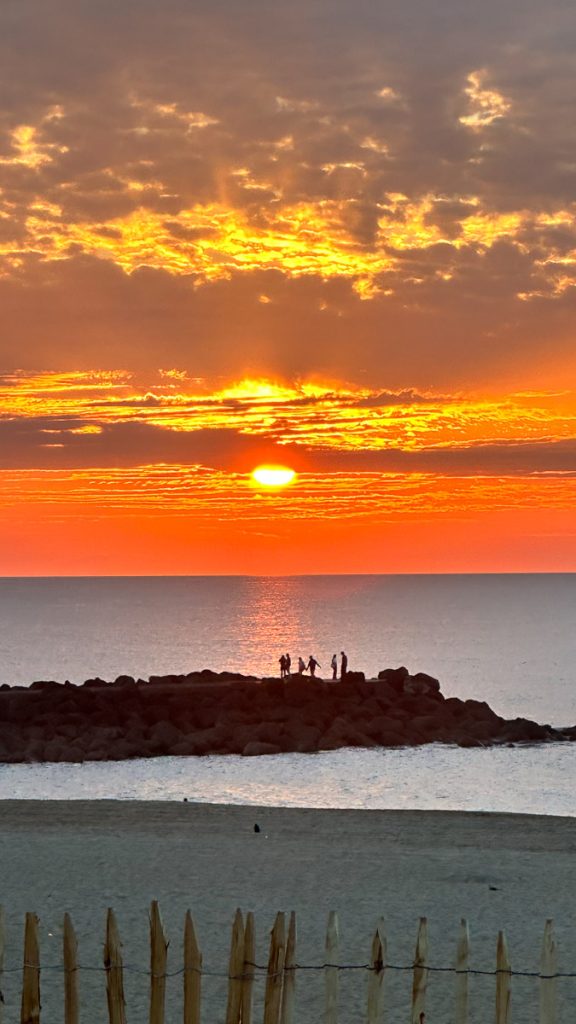Silhouette face à un coucher de soleil, symbolisant le chemin intérieur et l'ouverture vers soi.